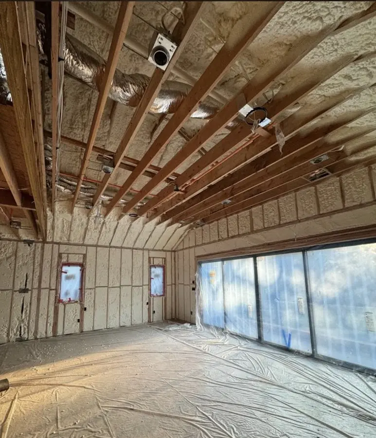 Interior walls and ceiling insulated with spray foam during new construction in Lansing